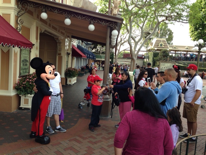 Posing with Mickey at Disneyland